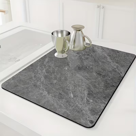 Gray marble-patterned mat on a kitchen counter with a sink in the background