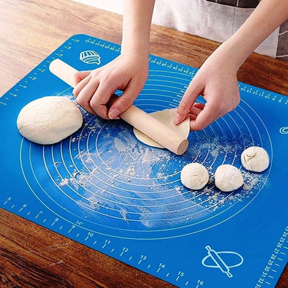 Person rolling dough on a blue baking mat with measurements